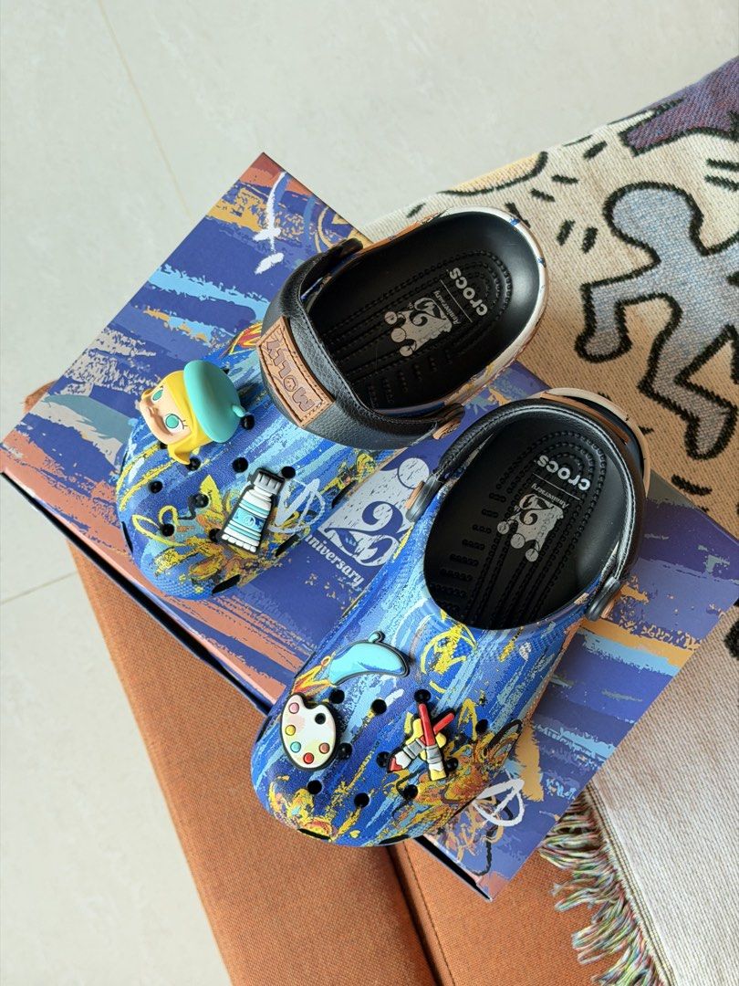 Crocs x Pop Mart Molly Artist Collection Clogs (Category: Slippers and slides) located in Taguig. Submitted by Yukandfriends (Listing ID 1459994222, Image 2). Description: - Authentic Crocs x Pop Mart Molly collaboration clogs. - Features an artist theme with unique paint tube and palette Jibbitz. - Stylish blue base with an abstract paint splatter design. - Comes complete with the original box. - A must-have for collectors and fans of Molly and 