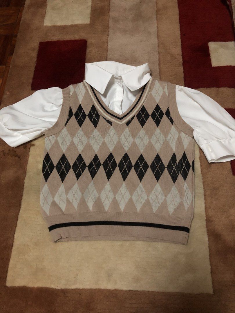Cute Argyle Vest with White Collared Shirt Set (Category: Others Tops) located in Bulacan. Submitted by shinzyx (Listing ID 1460019813, Image 1). Description: - Two-piece set: beige argyle knit vest and white collared shirt. - Vest features V-neck and ribbed trim. - Shirt has a classic collar and puff sleeves. - Ideal for a preppy or casual style. - Easy to layer for versatile outfits..