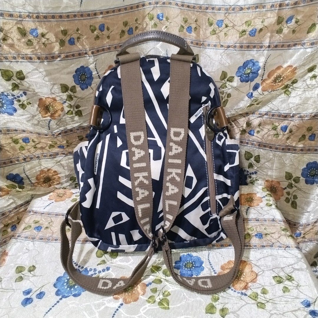 DAIKAI Navy Blue White Abstract Print Backpack (Category: Backpacks) located in Malabon City. Submitted by naughty_09 (Listing ID 1459973054, Image 2). Description: - Cool navy blue backpack with a stylish white abstract print. - Secure clasp closure on the front pocket for easy access. - Adjustable straps featuring the prominent DAIKAI logo. - Convenient side pockets for water bottles or essentials. - Main zippered compartment for larger items. 