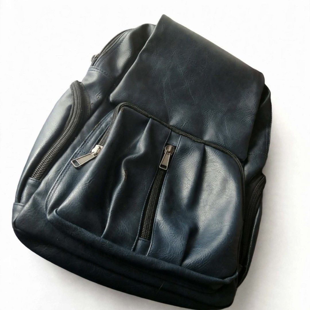 Dark Blue Faux Leather Backpack with Multiple Zippers (Category: Backpacks) located in Manila. Submitted by roseannlmn66895 (Listing ID 1459974228, Image 1). Description: *Dark Blue Faux Leather Backpack - ₱350 (negotiable)* Condition: Used - may mga tuklap pero matibay pa ✅ All zippers working ✅ Flap with magnetic button + zipper closure ✅ 2 side pockets ✅ Adjustable straps ✅ Spacious - kasya laptop / notebooks ✅ With small zip pocket inside Iss