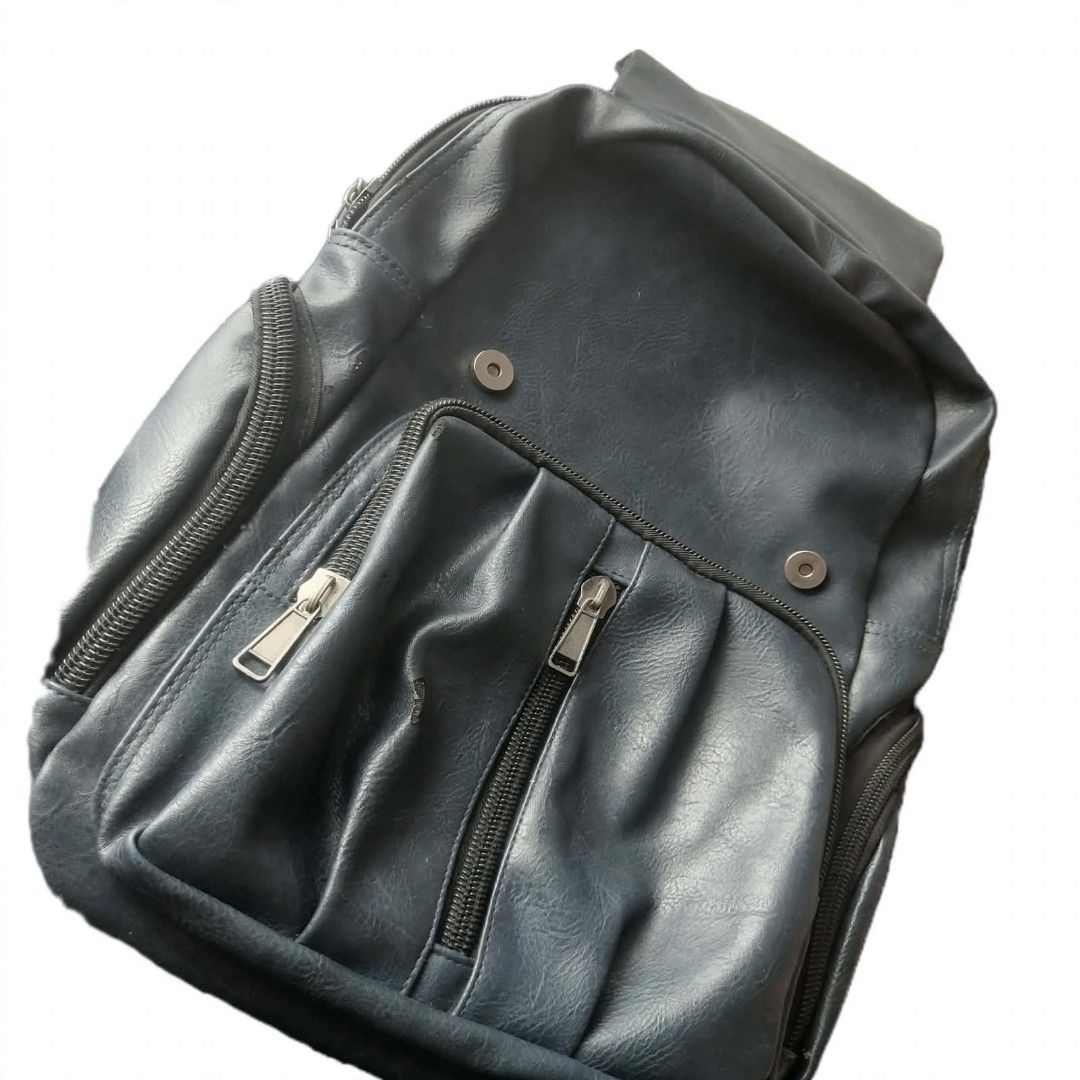 Dark Blue Faux Leather Backpack with Multiple Zippers (Category: Backpacks) located in Manila. Submitted by roseannlmn66895 (Listing ID 1459974228, Image 2). Description: *Dark Blue Faux Leather Backpack - ₱350 (negotiable)* Condition: Used - may mga tuklap pero matibay pa ✅ All zippers working ✅ Flap with magnetic button + zipper closure ✅ 2 side pockets ✅ Adjustable straps ✅ Spacious - kasya laptop / notebooks ✅ With small zip pocket inside Iss