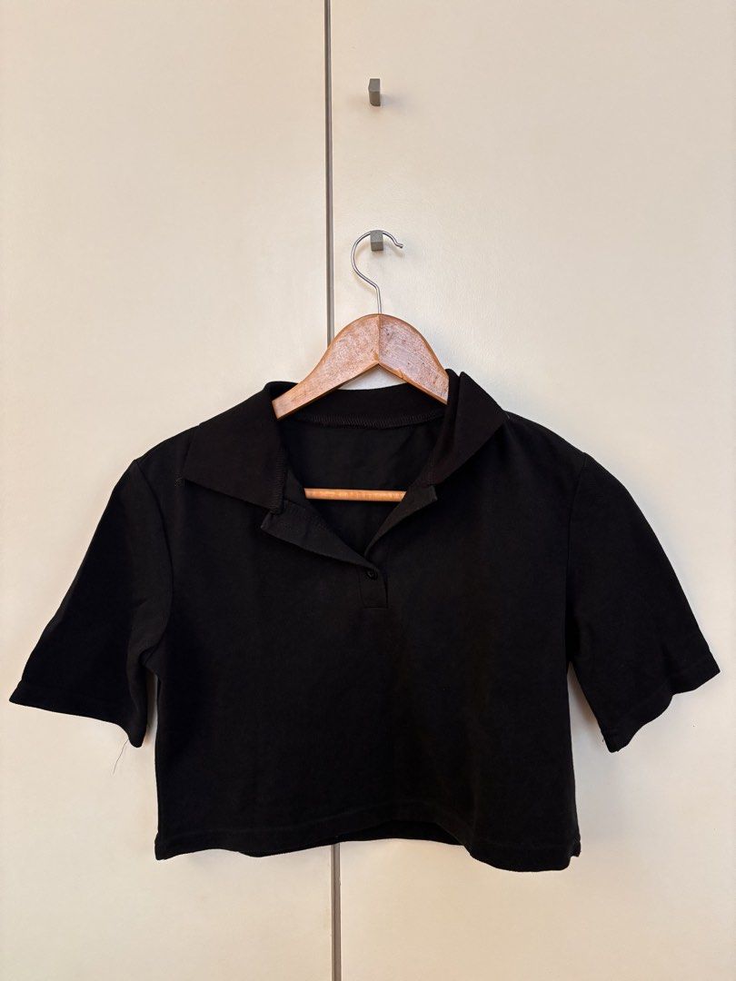 DAZY Black Collared Cropped Polo Shirt Size S (Category: Blouses) located in Manila. Submitted by mitzdcstr6 (Listing ID 1459980736, Image 1). Description: - Brand: DAZY - Style: Cropped Polo Shirt - Color: Black - Neckline: Collared - Sleeves: Short - Details: Button front - Origin: Made in China - Size: S - Styling Tip: Pairs well with high-waisted bottoms.