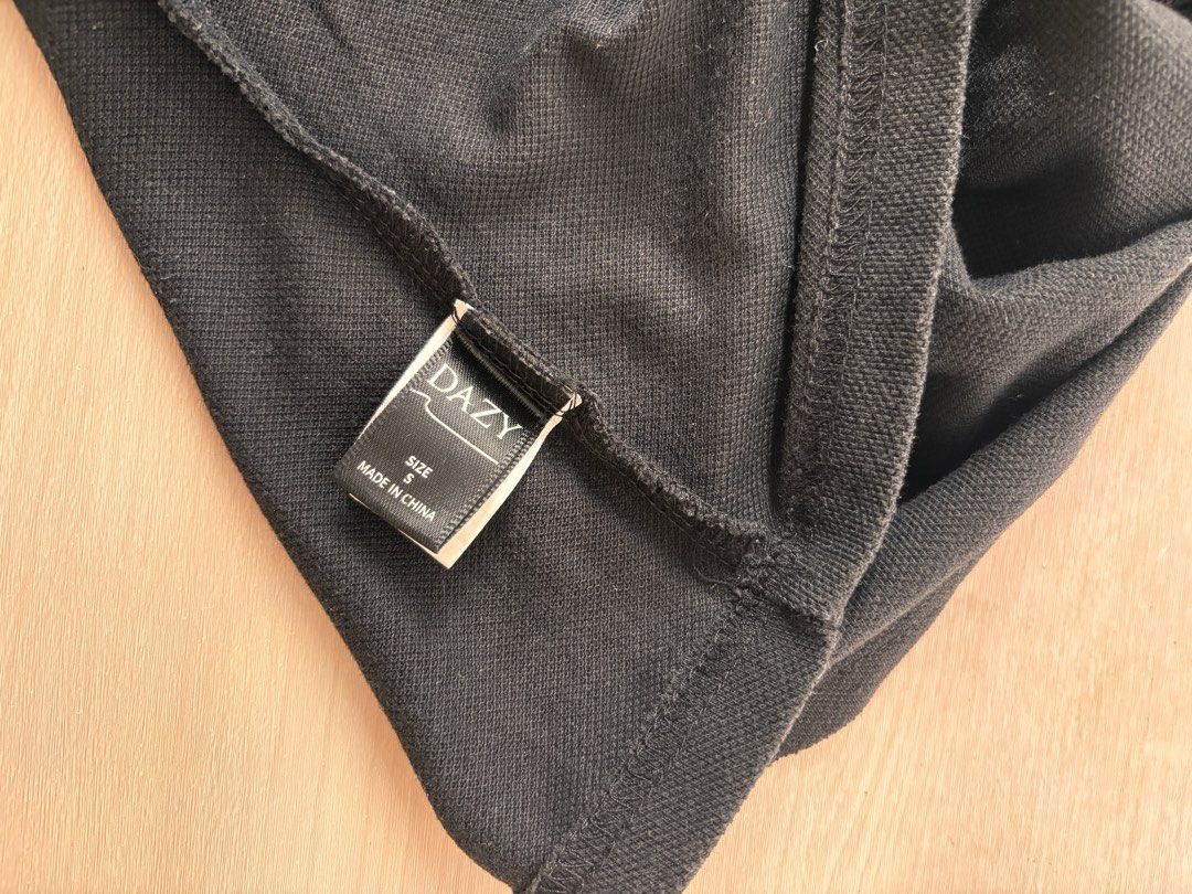 DAZY Black Collared Cropped Polo Shirt Size S (Category: Blouses) located in Manila. Submitted by mitzdcstr6 (Listing ID 1459980736, Image 3). Description: - Brand: DAZY - Style: Cropped Polo Shirt - Color: Black - Neckline: Collared - Sleeves: Short - Details: Button front - Origin: Made in China - Size: S - Styling Tip: Pairs well with high-waisted bottoms.