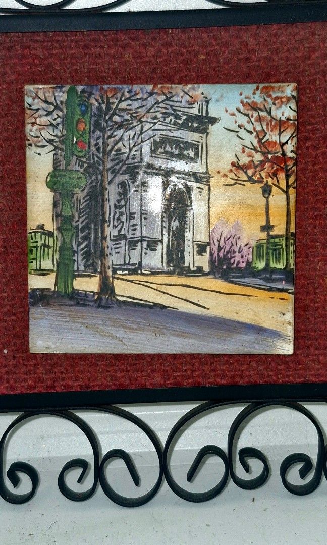 Decorative Framed Arc de Triomphe Artwork with Ornate Metal Frame (Category: Frames & Pictures) located in Quezon City. Submitted by belikabim2014 (Listing ID 1460096758, Image 3). Description: - Square framed artwork with a watercolor street scene. - Features trees and buildings in the painting. - Matted with textured red fabric. - Set in a black ornate metal scrollwork frame. - Includes brown backing board and hanging string. - A unique decorat