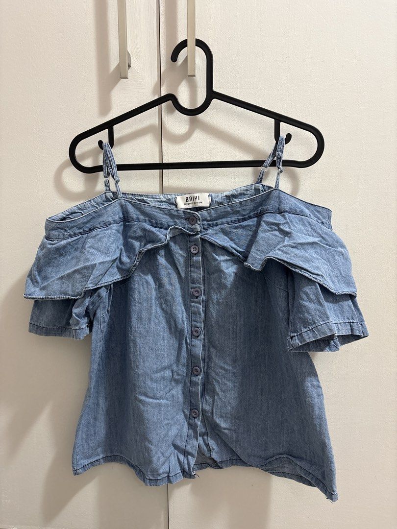 Denim Off-Shoulder Ruffle Top (Category: Sleeveless) located in Caloocan City. Submitted by preloved_tiffanyycollects (Listing ID 1460103041, Image 1). Description: - Light wash denim top - Off-shoulder design with ruffled sleeves - Button-up front - Adjustable spaghetti straps - Perfect for casual outings or nights with friends.