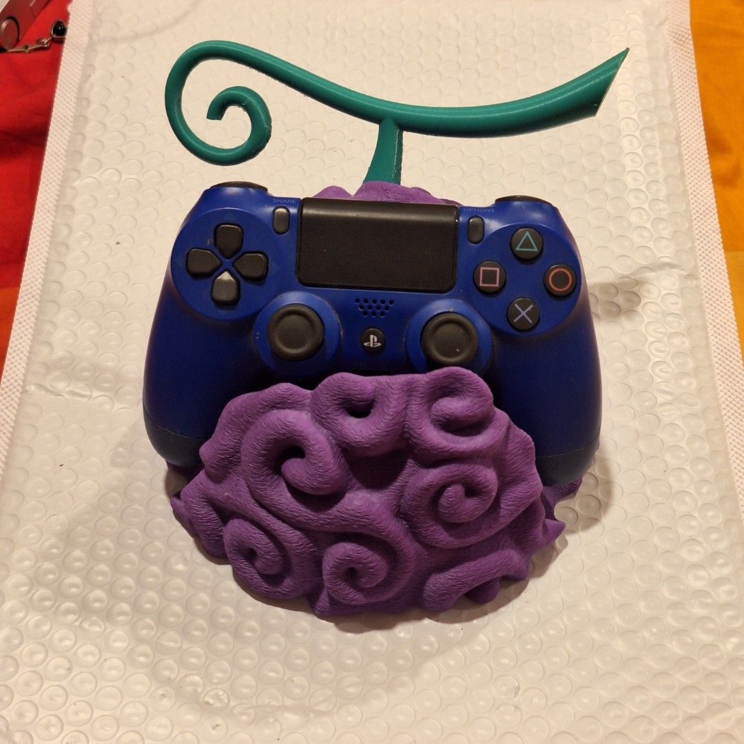 Devil Fruit Control Holder (Category: Controllers) located in Petaling Jaya. Submitted by m.y.r.x (Listing ID 1460095086, Image 1). Description: Devil Fruit - One Piece Perfect for Game Controller Display Good Gift for gamers (Never Used) (Blue Game Controller not included).