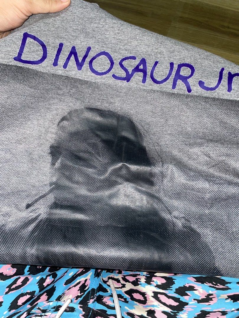Dinosaur Jr. Graphic T-Shirt (Category: Tshirts & Polo Shirts ) located in Manila. Submitted by clementdav22513 (Listing ID 1460033263, Image 3). Description: - Grey t-shirt with Dinosaur Jr. graphic print - Band name "Dinosaur Jr." in purple text above graphic - Stain present on the inside collar area - Original tag still attached - Size: Small.
