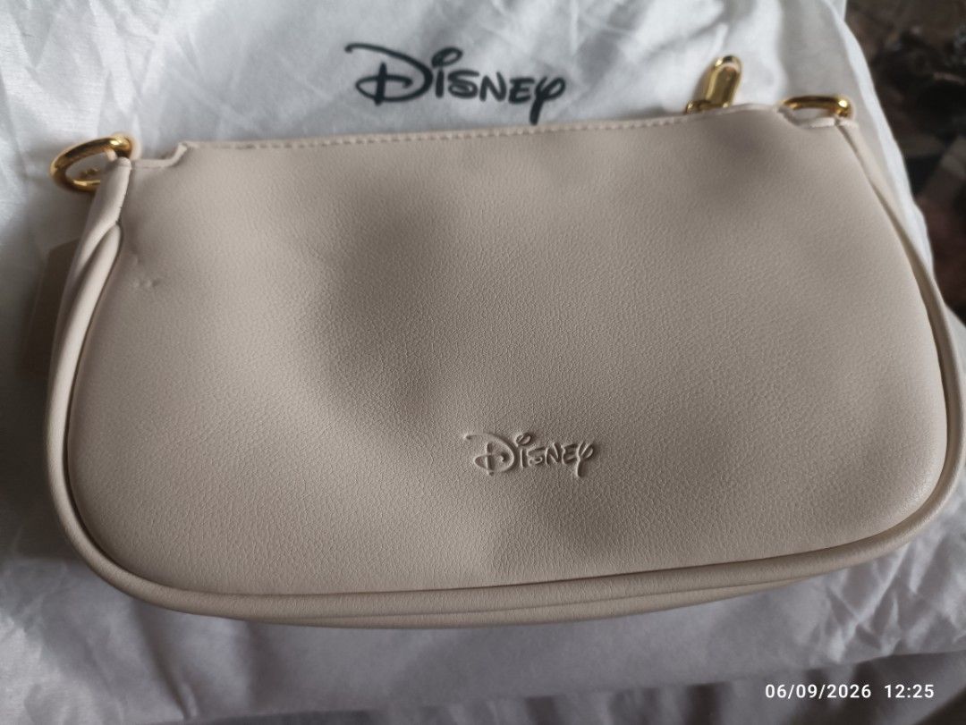 Disney Mickey Mouse Cream Minnie Mouse Shoulder Bag (Category: Shoulder Bags) located in Caloocan City. Submitted by calm.gentle.carleenballes (Listing ID 1459941908, Image 3). Description: - Adorable cream-colored shoulder bag featuring a cute Minnie Mouse face design. - Comes with two adjustable straps: one thin and one wider strap for versatile styling. - Elegant gold hardware details add a touch of sophistication. - Authentic Disney branding 