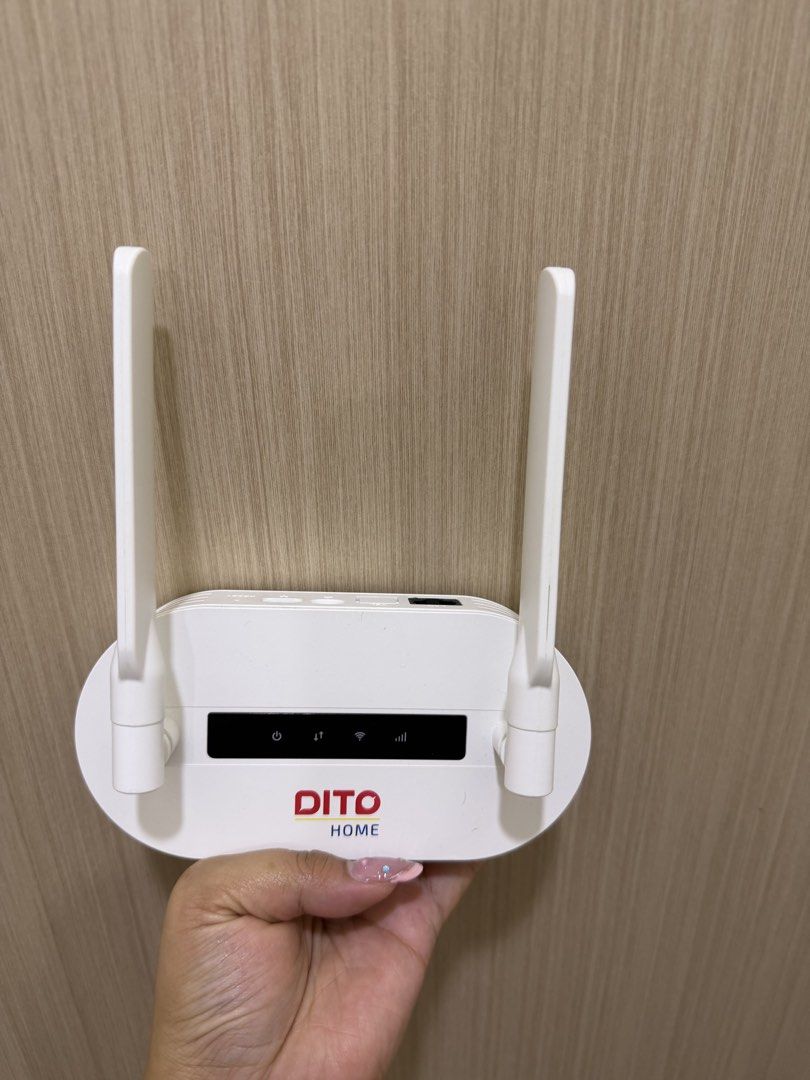 DITO Home WiFi Router with Antennas (Category: Networking) located in Quezon City. Submitted by cozykath (Listing ID 1459958819, Image 1). Description: - White DITO Home WiFi router - Includes two antennas for enhanced signal strength - Features indicator lights for Power, Internet, and WiFi - Ideal for setting up your home internet connection - Tested and confirmed to be working No simcard .