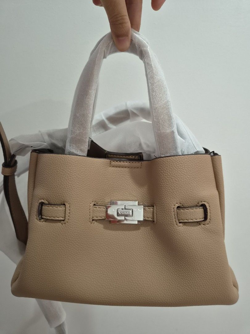 DKNY Pebble Leather Tote Bag (Category: Tote Bags) located in Taytay. Submitted by passiveincome89 (Listing ID 1460001922, Image 1). Description: - Authentic DKNY pebble leather tote bag - Includes original dust bag and tags - Elegant silver hardware with prominent DKNY logo - Spacious interior with multiple compartments for organization - Ideal for everyday use, work, or travel.