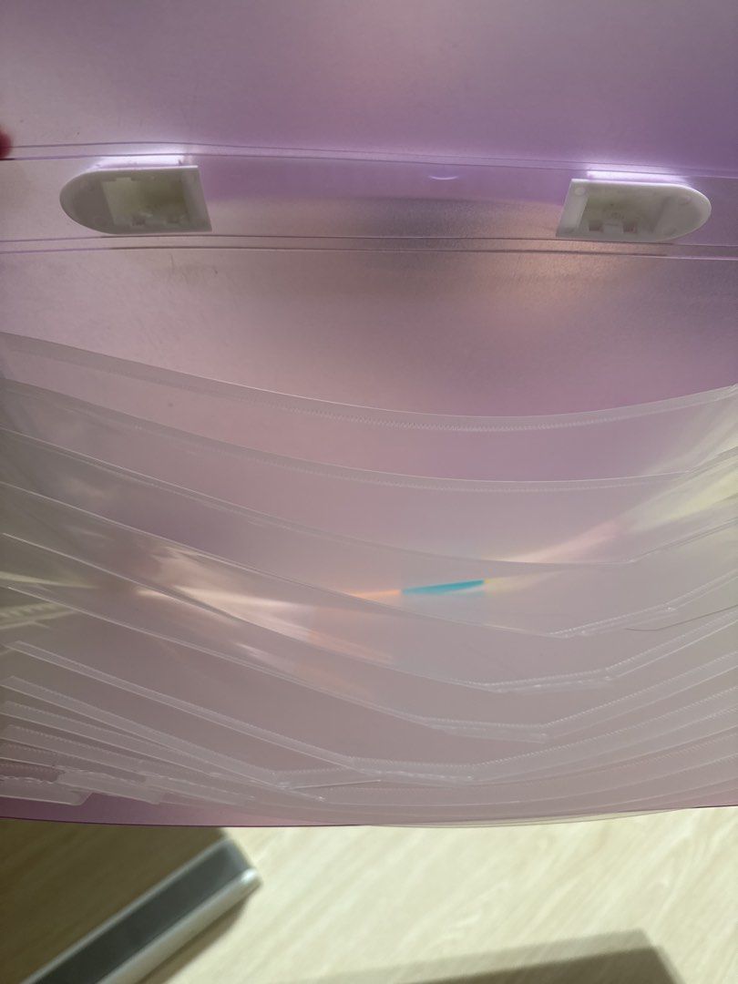 Document Folder with Multiple Pockets (Category: Stationery & School Supplies) located in Singapore. Submitted by catnip2 (Listing ID 1460033058, Image 2). Description: - Vibrant purple plastic folder - Multiple clear pockets for document organization - Flexible and securely attached handle - Perfect for school or office use - Keeps documents tidy and easily accessible - Convenient for carrying.
