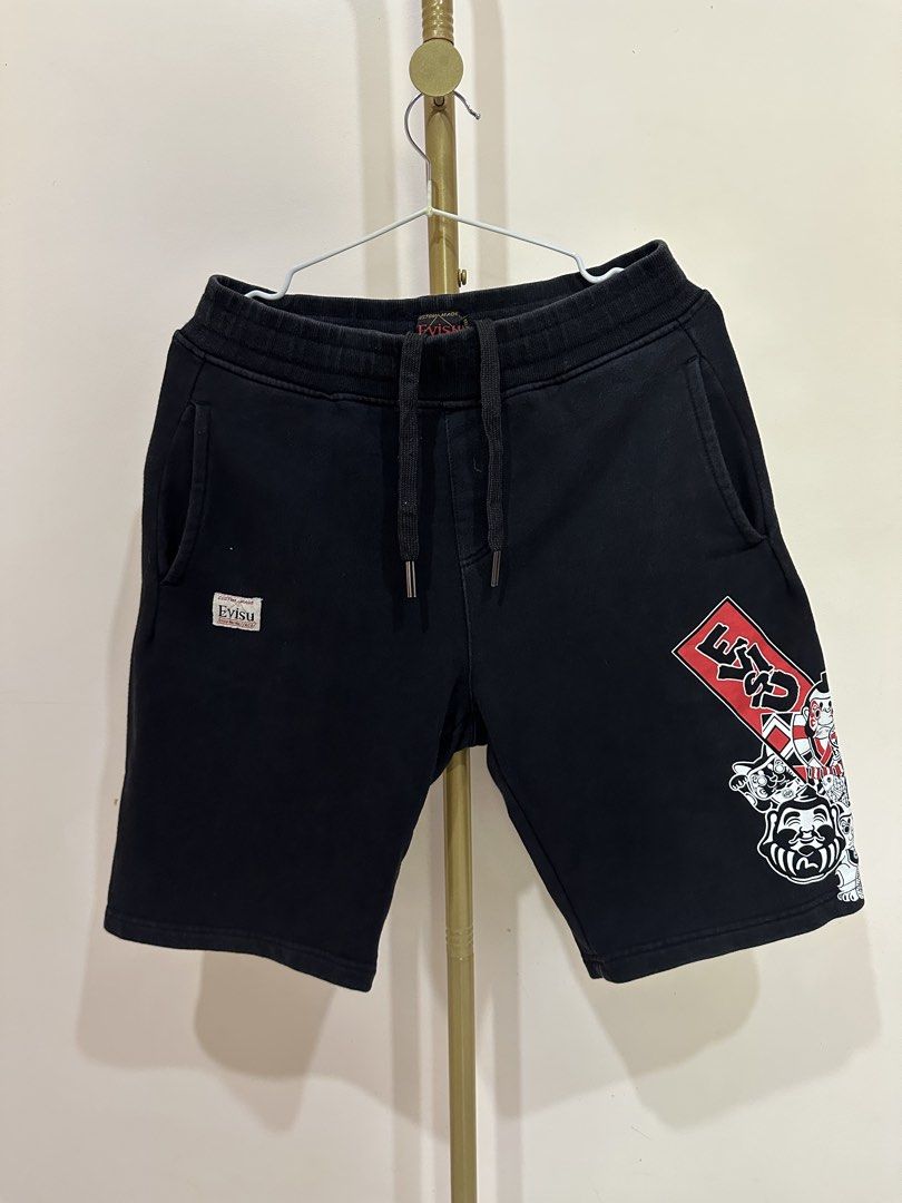 Evisu Black Shorts with Graphic Print (Category: Shorts) located in Tacloban City. Submitted by ikonicthrifts (Listing ID 1459914573, Image 1). Description: - Black Evisu shorts -Size 28-32 waist, L-19.5 - Graphic print on side and back - Elastic waistband with drawstring - Two side pockets and one back pocket - See photos for issues - Comfortable material - Ideal for casual wear.