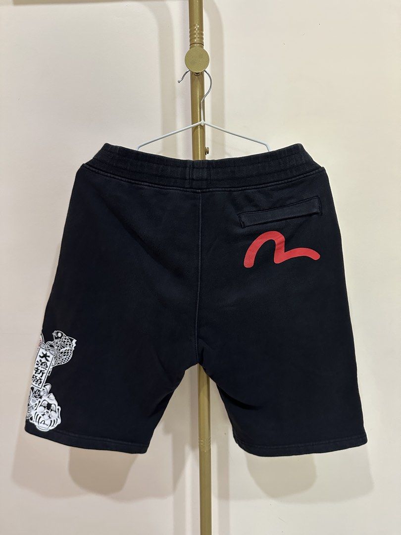 Evisu Black Shorts with Graphic Print (Category: Shorts) located in Tacloban City. Submitted by ikonicthrifts (Listing ID 1459914573, Image 2). Description: - Black Evisu shorts -Size 28-32 waist, L-19.5 - Graphic print on side and back - Elastic waistband with drawstring - Two side pockets and one back pocket - See photos for issues - Comfortable material - Ideal for casual wear.