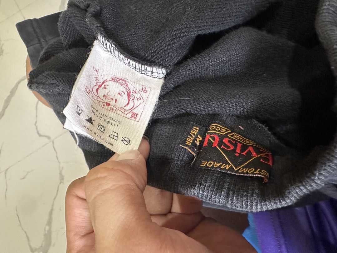 Evisu Black Shorts with Graphic Print (Category: Shorts) located in Tacloban City. Submitted by ikonicthrifts (Listing ID 1459914573, Image 3). Description: - Black Evisu shorts -Size 28-32 waist, L-19.5 - Graphic print on side and back - Elastic waistband with drawstring - Two side pockets and one back pocket - See photos for issues - Comfortable material - Ideal for casual wear.