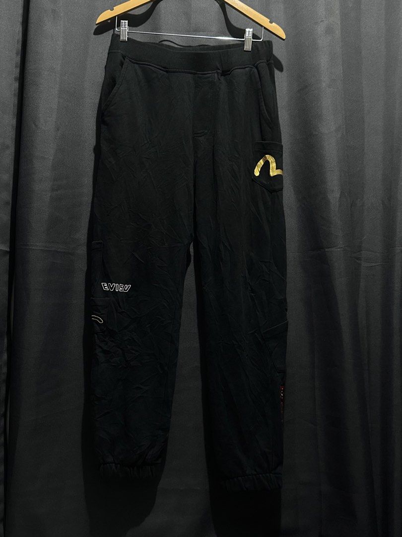 Evisu Embroidered Multi-Pocket Sweatpants / Joggers (Category: Joggers) located in Buenavista. Submitted by themodernrack (Listing ID 1460035982, Image 1). Description: Brand: Evisu Color: Black Style: Heavyweight Sweatpants / Jogger Pants (Features multi-pocket design, embroidered Evisu Seagull branding with graphic infill pattern, Japanese kanji character embroidery, side cargo pockets, and elasticated hem cuffs) Condition: Good used condition 