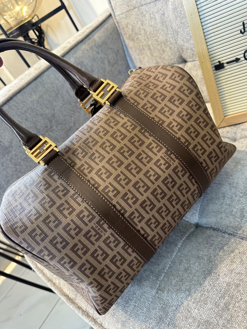 Fendi Zucca Boston Bag (Category: Luxury Bags & Wallets) located in Los Banos. Submitted by joshua_morales (Listing ID 1460075727, Image 2). Description: - Classic Fendi Boston bag - Iconic Zucca print in brown and tan canvas - Genuine leather trim - Gold hardware details - Comes with original lock and key - Ideal size for daily essentials - A timeless and stylish accessory.