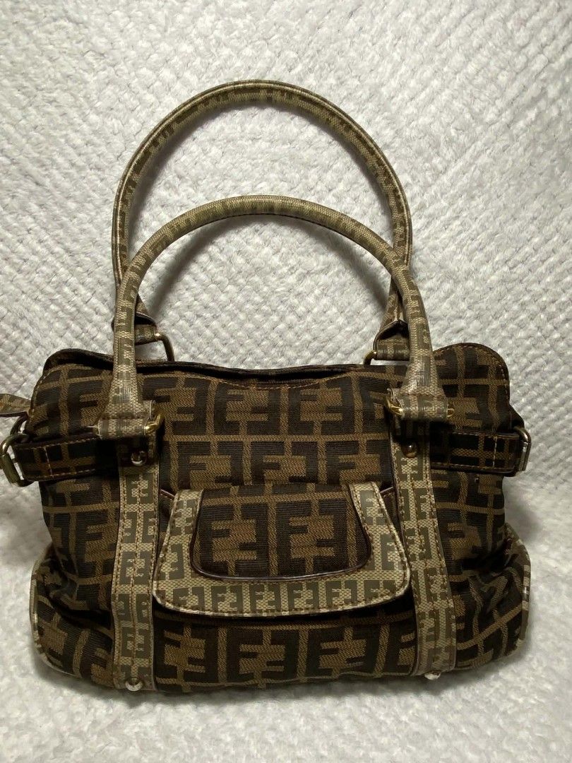 Fendi Zucca Canvas Handbag (Category: Luxury Bags & Wallets) located in Baguio. Submitted by leah_rodrigo (Listing ID 1460044182, Image 1). Description: - Classic Fendi Zucca pattern handbag - Color: Brown and tan canvas with leather trim - Features: Top handles for carrying, front pocket detail - Style: Stylish everyday bag - Condition: Shows some signs of wear but still has plenty of life left.