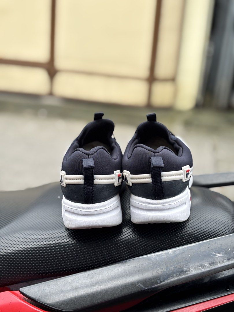Fila Black White Sneakers (Category: Babies & Kids Fashion) located in San Fernando. Submitted by kickslocker (Listing ID 1460047697, Image 3). Description: - Fila sneakers - Color: Black and White - Size: 21cm - Condition: Excellent - Design: Slip-on with elastic laces - Features: Prominent Fila logo on side and sole - Ideal for: Everyday wear.