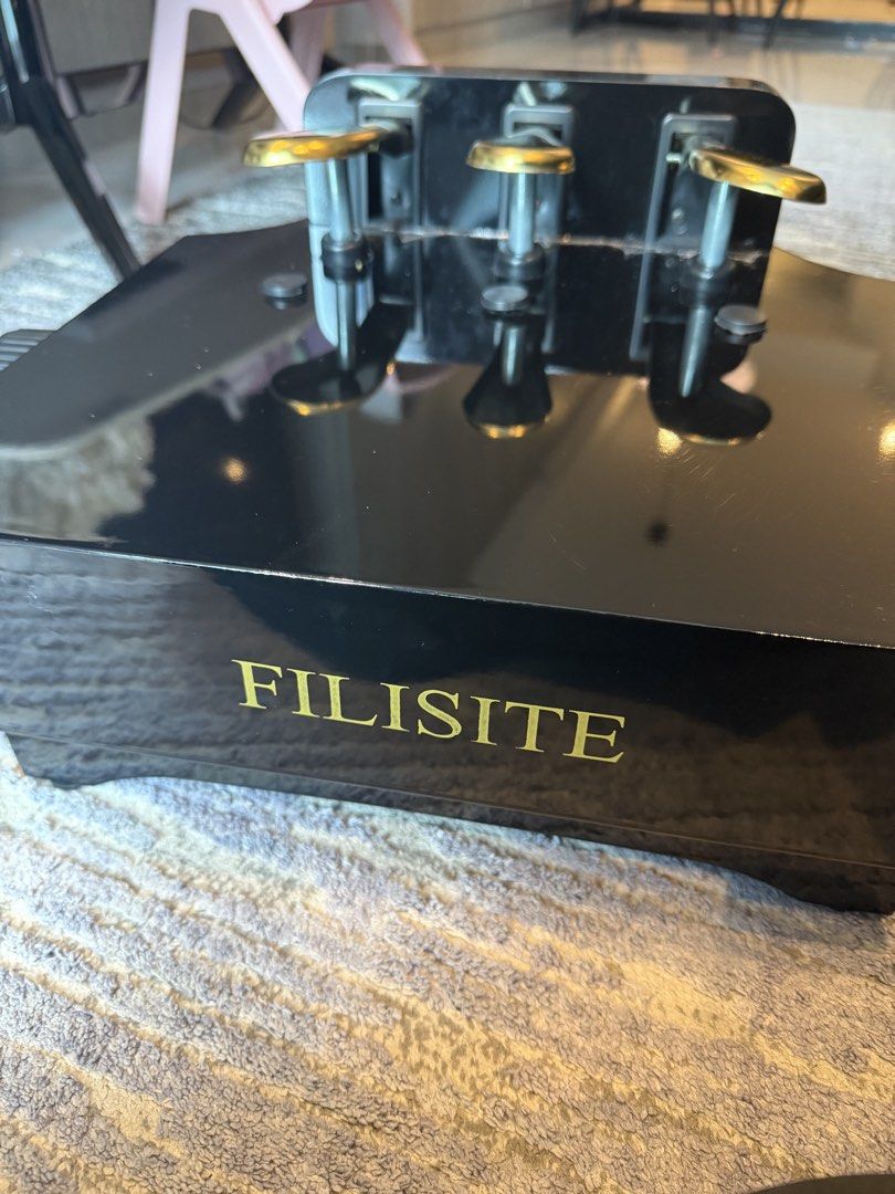 Filisite Piano Pedal Unit extender (Category: Musical Instruments) located in Taguig. Submitted by decentfinds18 (Listing ID 1459917646, Image 1). Description: - Filisite black piano pedal unit - Three pedals with elegant gold accents - Adjustable knobs on the sides for customization - Designed for digital pianos - Excellent for both practice sessions and live performances.