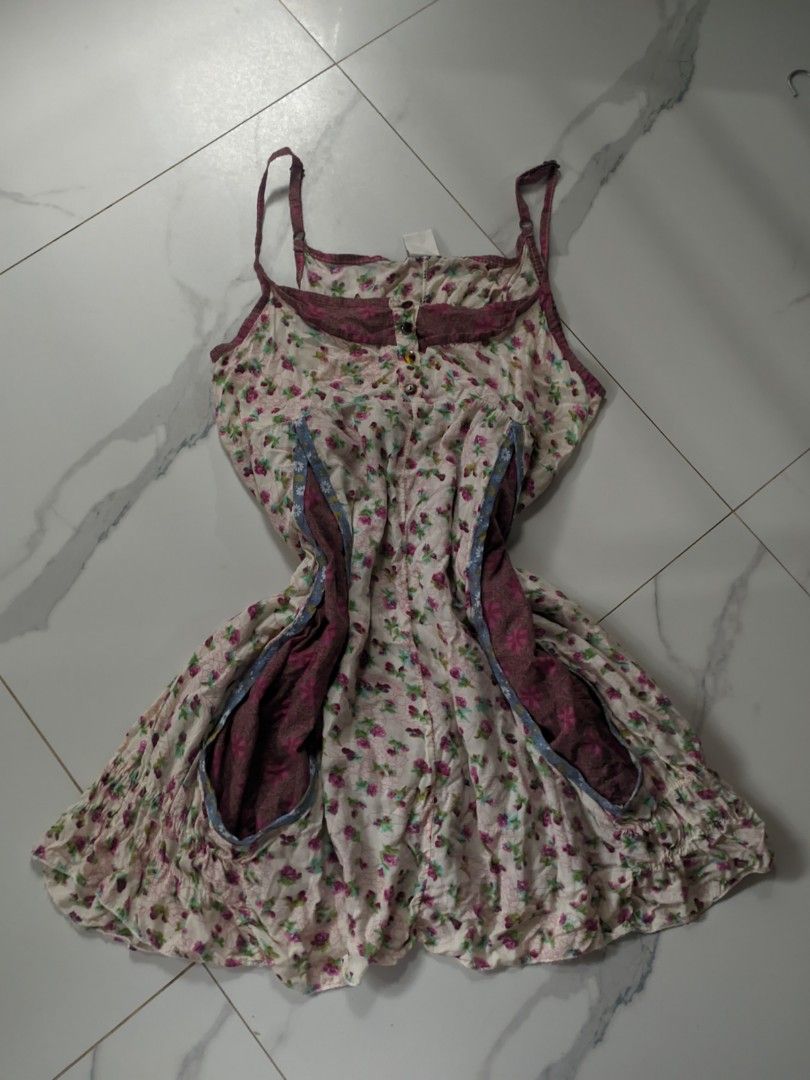 Floral Print Spaghetti Strap Dress with Pockets (Category: Dresses) located in Lian. Submitted by rosettasclo (Listing ID 1459941498, Image 1). Description: - Adorable floral print dress - Cream base with charming pink and purple flowers - Delicate spaghetti straps - Convenient side pockets with contrasting darker floral lining - Stylish button detail down the front - Flirty ruffled hem - Ideal for casual outings and everyday wear.