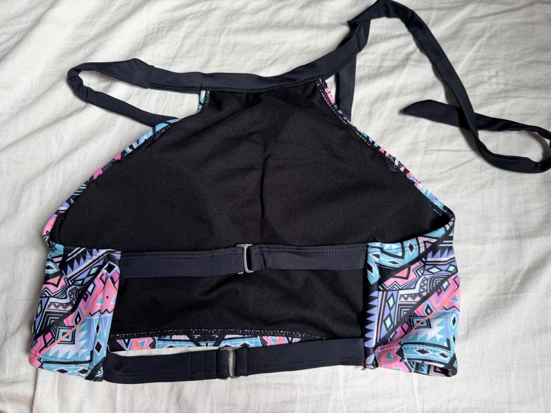 Geometric Print Halter Neck Bikini Top (Category: Bikinis & Swimsuits) located in Quezon City. Submitted by cozykath (Listing ID 1459985987, Image 2). Description: - Colorful halter neck bikini top - Bold geometric print in pink, blue, and purple - Ties at neck and back for adjustable fit - Clasp closure at the back - Ideal for beach trips and pool days.