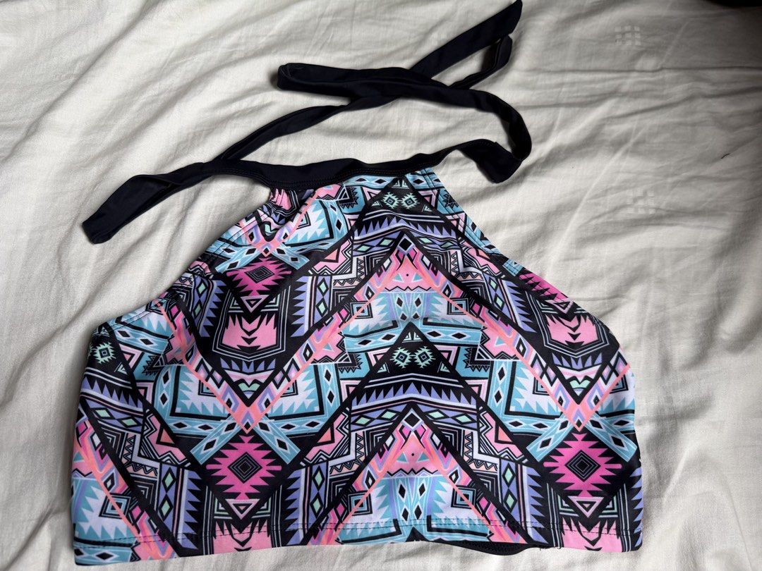 Geometric Print Halter Neck Bikini Top (Category: Bikinis & Swimsuits) located in Quezon City. Submitted by cozykath (Listing ID 1459985987, Image 1). Description: - Colorful halter neck bikini top - Bold geometric print in pink, blue, and purple - Ties at neck and back for adjustable fit - Clasp closure at the back - Ideal for beach trips and pool days.