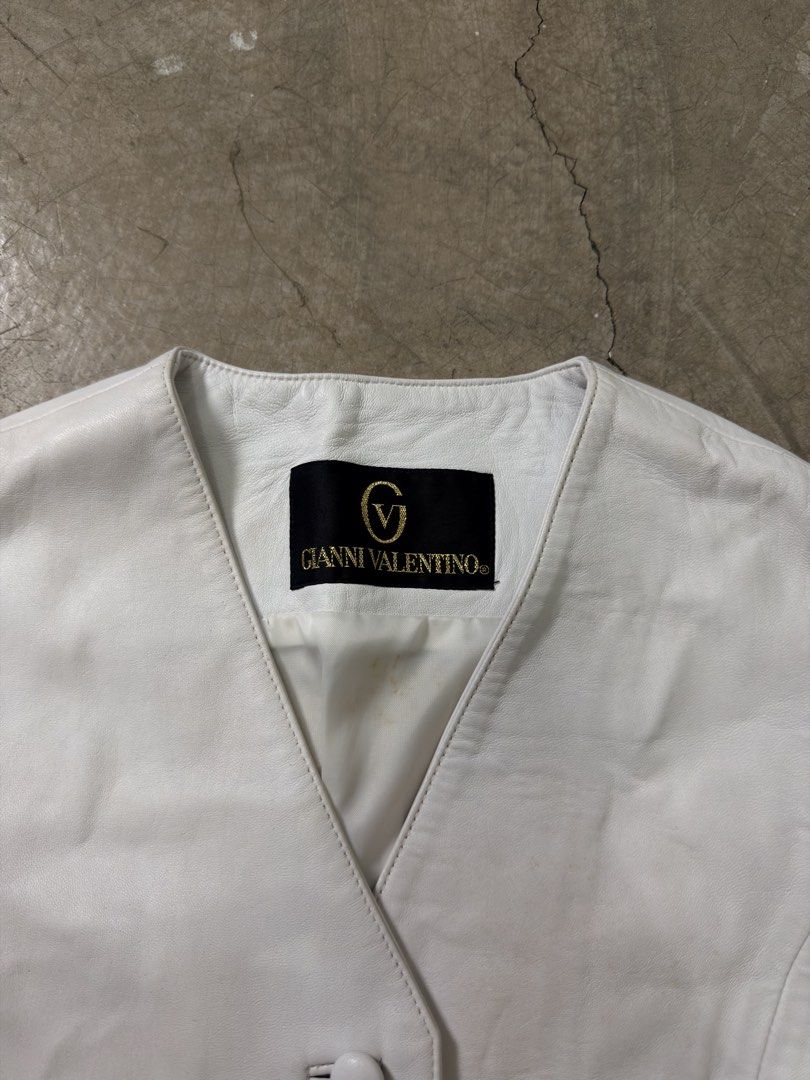 Gianni Valentino White Leather Vest (Category: Others Tops) located in Alfonso. Submitted by jbcamet (Listing ID 1460078196, Image 2). Description: - Genuine Gianni Valentino white leather vest - Classic button front closure - Two functional front pockets - Adjustable buckle at the back for a customized fit - Smooth lined interior - Ideal layering piece for any outfit.