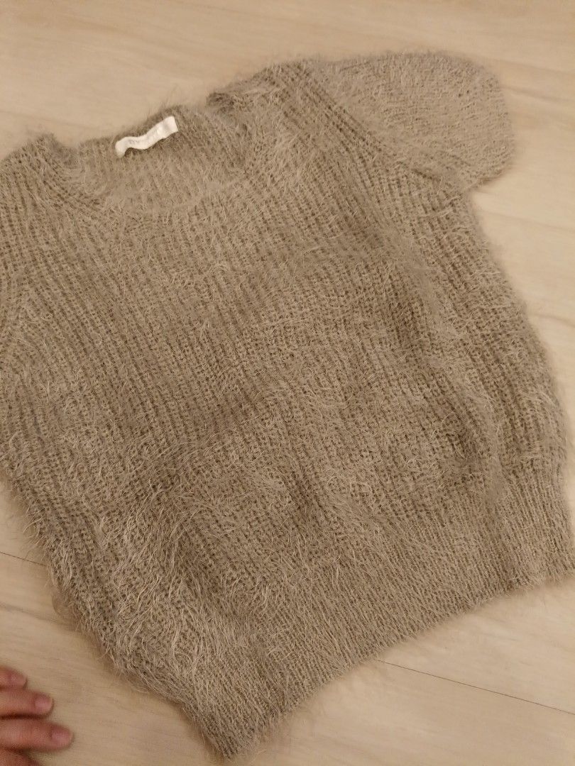 Gold Blouse (Category: Blouses) located in Quezon City. Submitted by 2sweetie (Listing ID 1460064969, Image 3). Description: - Brand: NYUNYU (Imported from Korea) - Style: Fuzzy/Textured Blouse - Size: S (EU 36 / UK 8 / US 4) - Color: Neutral/Gold-ish tone - Condition: 4/5 (Excellent) - Design: Short sleeves, cozy texture.