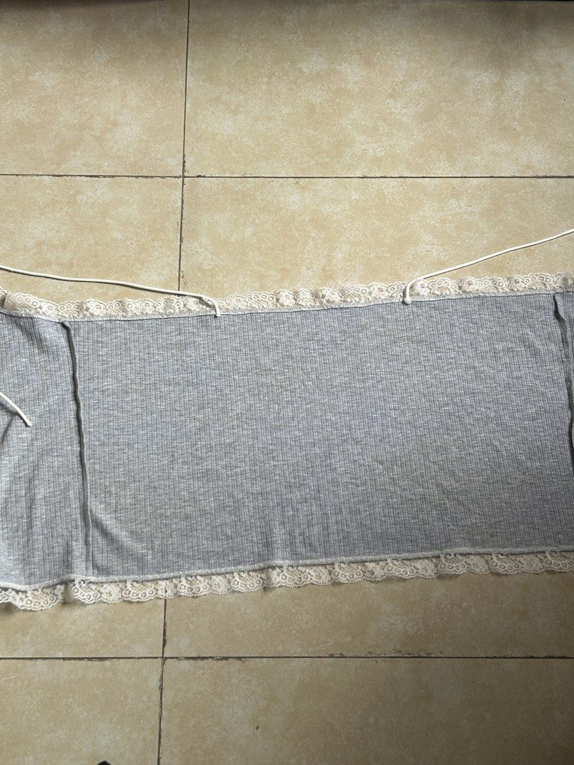 Grey Lace Trim Camisole Tie Front Top (Category: Sleeveless) located in Pasig City. Submitted by eddwuhrd (Listing ID 1459990262, Image 2). Description: - Cute grey camisole top - Ribbed material with delicate lace trim - Adjustable straps for a perfect fit - Front tie closure for a stylish detail - Super comfy and soft, ideal for loungewear - Versatile for layering or casual wear.