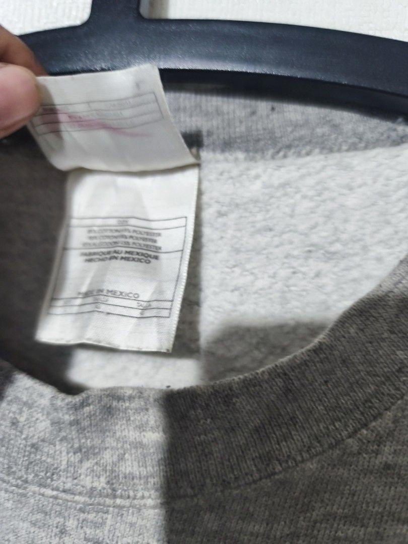 Grey Nike Crewneck Sweatshirt (Category: Coats, Jackets and Outerwear) located in Pasay City. Submitted by tananoy0508061 (Listing ID 1460076863, Image 3). Description: - Grey Nike crewneck sweatshirt - Size: L - Small embroidered Nike swoosh on chest - Label with 'L-24.5 x 27.5' included - Minor faint yellow stains on the front - Made in Mexico.