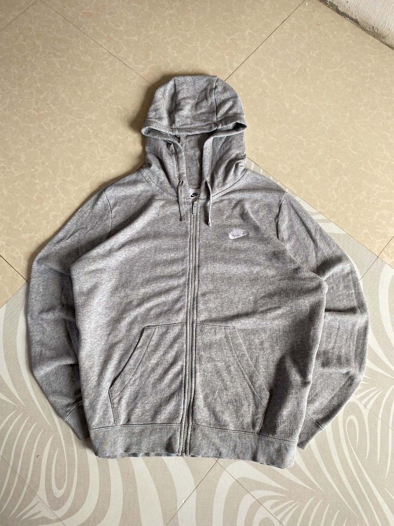 Grey Nike Zip-Up Hoodie (Category: Coats, Jackets and Outerwear) located in Angeles City. Submitted by dathrifthaven (Listing ID 1460078695, Image 1). Description: Nike Zip-up Hoodie 2XL on tag Authentic/Original Excellent to like new 9.8/10 overall Fully embroidered Color may vary due to lighting condition. Dimes: Length: 28 Width: 26.5.