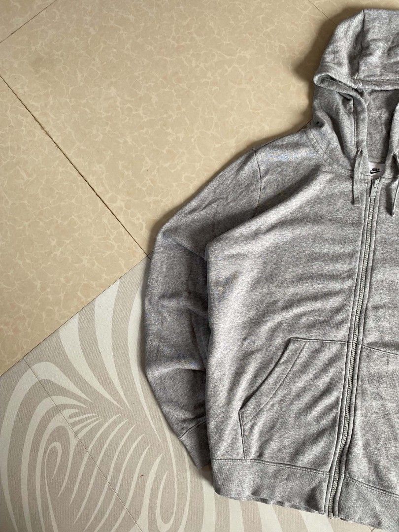 Grey Nike Zip-Up Hoodie (Category: Coats, Jackets and Outerwear) located in Angeles City. Submitted by dathrifthaven (Listing ID 1460078695, Image 2). Description: Nike Zip-up Hoodie 2XL on tag Authentic/Original Excellent to like new 9.8/10 overall Fully embroidered Color may vary due to lighting condition. Dimes: Length: 28 Width: 26.5.