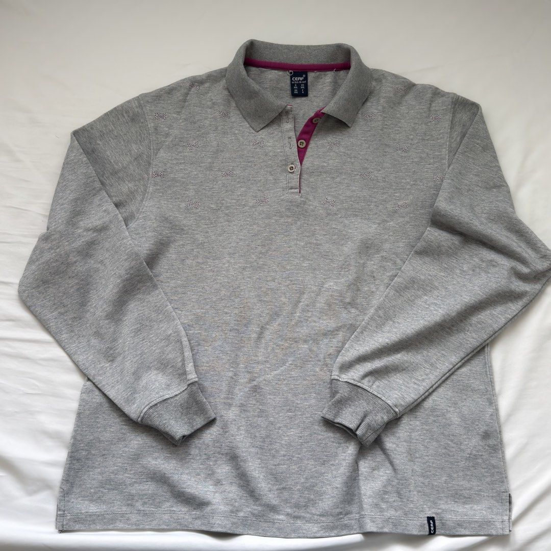 Grey Quarter Button Longsleeve Shirt (Category: Longsleeves) located in Kawit. Submitted by grazielaa (Listing ID 1460026070, Image 1). Description: - Grey sweater with collar - Small pink and white stripe bows across the chest .