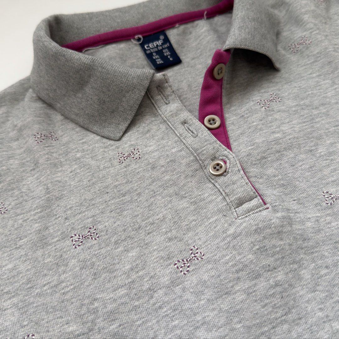 Grey Quarter Button Longsleeve Shirt (Category: Longsleeves) located in Kawit. Submitted by grazielaa (Listing ID 1460026070, Image 2). Description: - Grey sweater with collar - Small pink and white stripe bows across the chest .