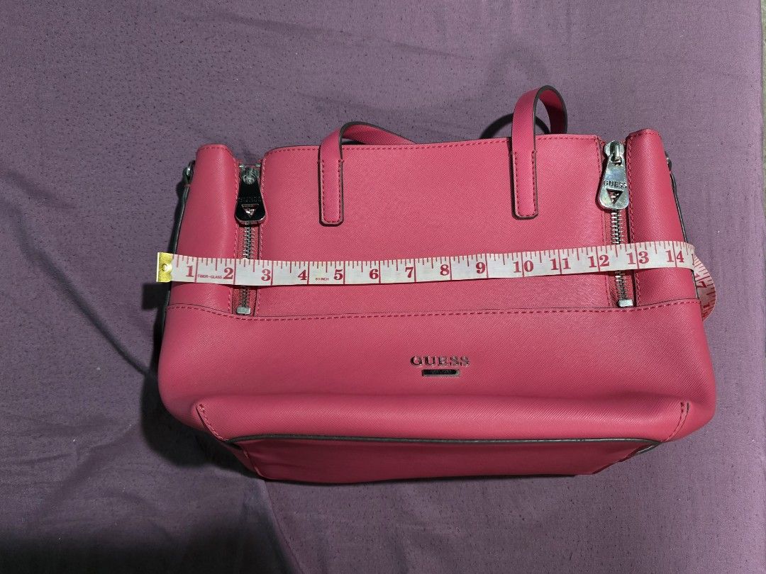 Guess Pink Tote Bag (Category: Tote Bags) located in Quezon City. Submitted by gabbie17 (Listing ID 1459994236, Image 2). Description: Turn heads with this vibrant, eye-catching hot pink GUESS tote! Perfectly structured with a textured saffiano finish, sturdy double top handles, and sleek silver-tone hardware featuring signature GUESS front pocket zipper pulls. ​Condition: Brand New ​Origin: Direct from US ​Price: ₱1,500 ​Color: Hot Pink / Fuchsi