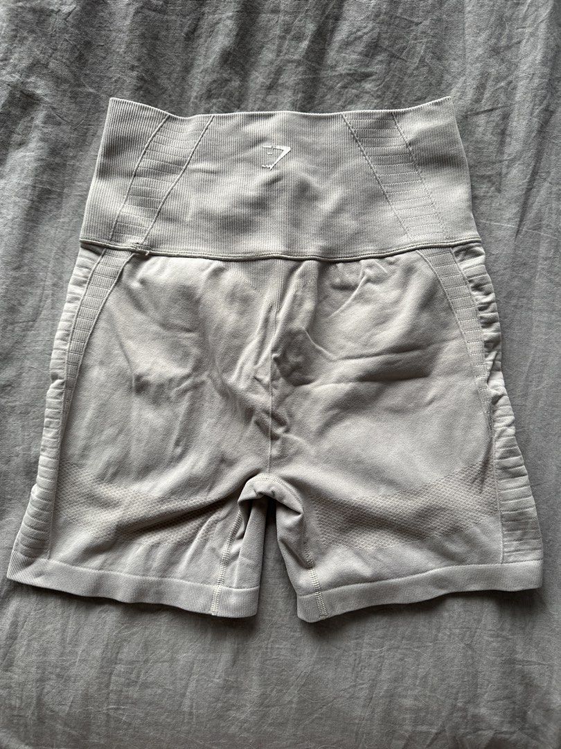 Gymshark Seamless Cycling Shorts - Light Grey (Category: Activewear) located in Manila. Submitted by rhaphina (Listing ID 1459999185, Image 2). Description: - Gymshark seamless cycling shorts in light grey - High-waisted design with a supportive ribbed waistband - Stylish textured detailing and trendy side cut-outs - Comfortable and provides excellent support for all your workouts - Ideal for running, gym sessions, or casual lounging.