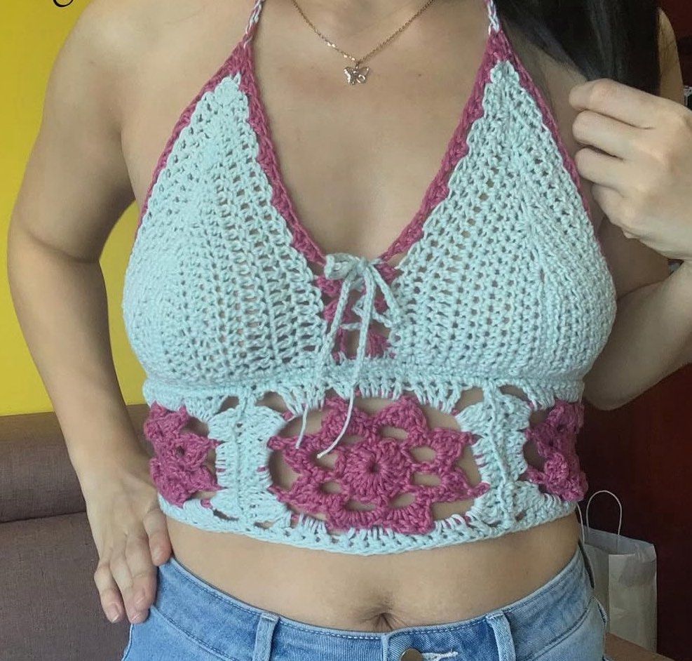 Handmade Crochet Halter Neck Crop Top (Category: Sleeveless) located in Manila. Submitted by silver.truemountain (Listing ID 1460068090, Image 1). Description: - Super cute handmade crochet halter top - Light blue with pink floral details - Lace-up front for adjustable fit - Perfect for festivals or a beach day - Unique, one-of-a-kind piece - Ideal for summer vibes.