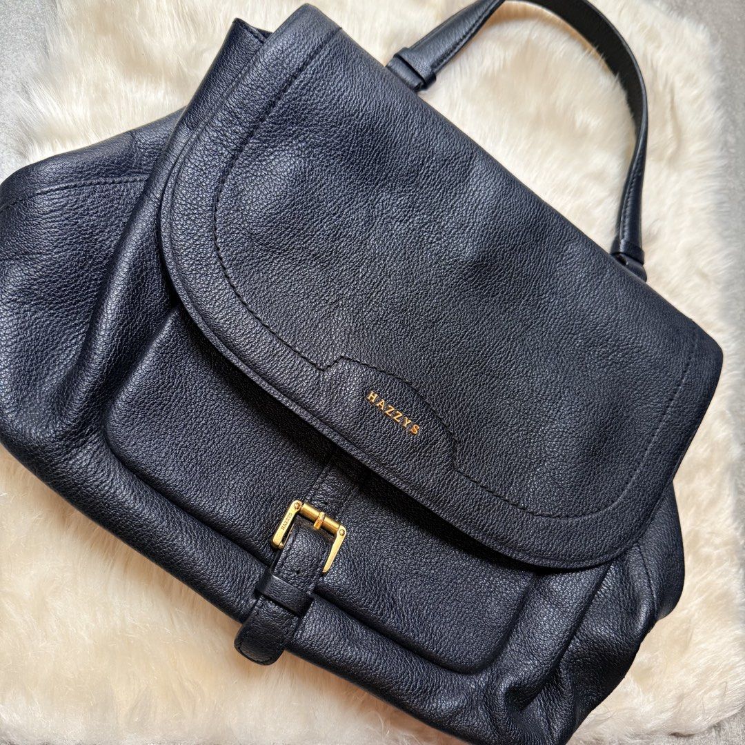 HAZZYS Black Leather Top Handle Bag (Category: Luxury Bags & Wallets) located in Cainta. Submitted by shangitta (Listing ID 1459953651, Image 1). Description: Selling this for a very low price because I’m declutterring :) Very classy and easy to pair with anything! • Black pebbled leather • Gold-tone HAZZYS hardware • Spacious interior with multiple compartments • Main zippered compartment for added security • Front buckle detail • Back pocket • 