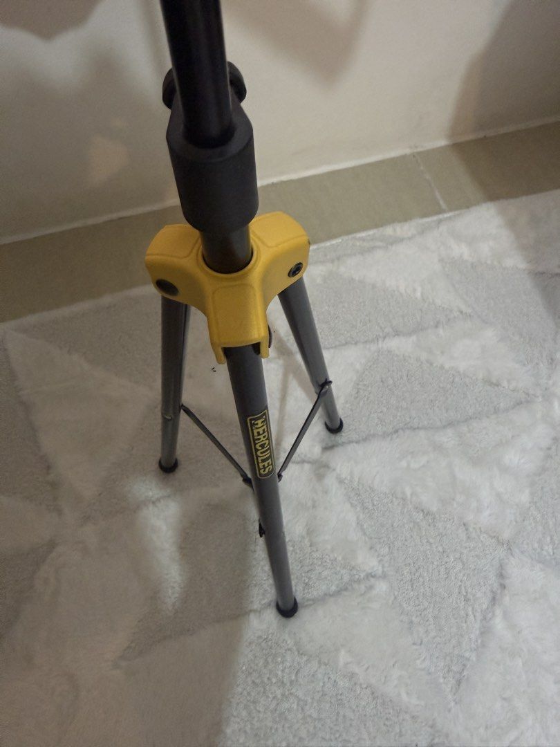 Hercules Music Stand (Category: Music Accessories) located in Manila. Submitted by blanknwhite (Listing ID 1459947342, Image 3). Description: - Black foldable music stand - Sturdy tripod base with yellow accents - Adjustable height for comfortable use - Easy to set up and pack away - Ideal for musicians, practice, or performance.