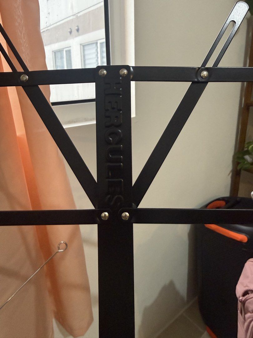 Hercules Music Stand (Category: Music Accessories) located in Manila. Submitted by blanknwhite (Listing ID 1459947342, Image 1). Description: - Black foldable music stand - Sturdy tripod base with yellow accents - Adjustable height for comfortable use - Easy to set up and pack away - Ideal for musicians, practice, or performance.
