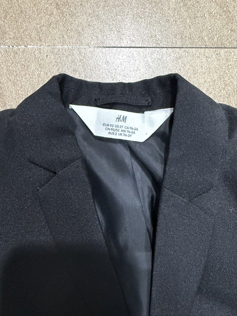 H&M Black Blazer Jacket for Kids (Category: Coats, Jackets and Outerwear) located in Pasig City. Submitted by cvj25 (Listing ID 1459946222, Image 3). Description: - H&M Black Blazer - Two-button closure - Front pockets - Fully lined interior - Versatile for formal events or smart casual outfits - Easily pairs with shirts or dresses.
