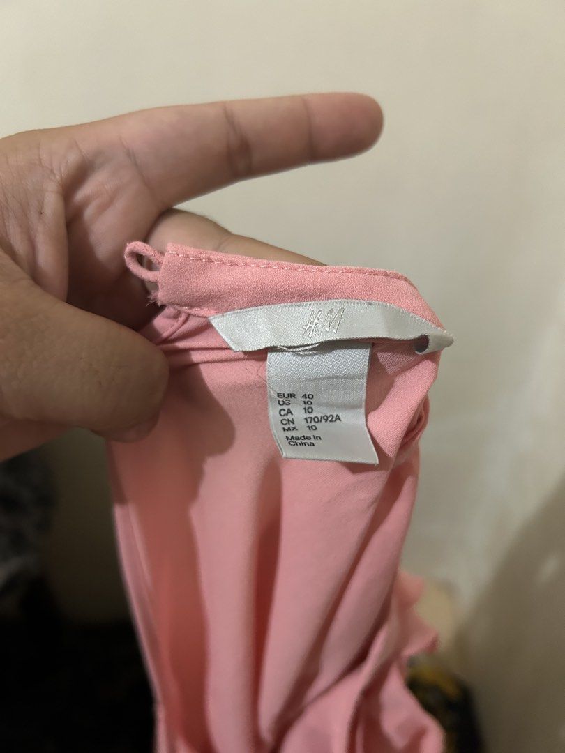 H&M Pink Ruffle Sleeveless Blouse (Category: Blouses) located in Naga. Submitted by aroaldaw (Listing ID 1460045115, Image 2). Description: - Cute pink sleeveless blouse from H&M - Features lovely ruffles down the front - Versatile for dressing up or down - Easy to wear for any occasion.