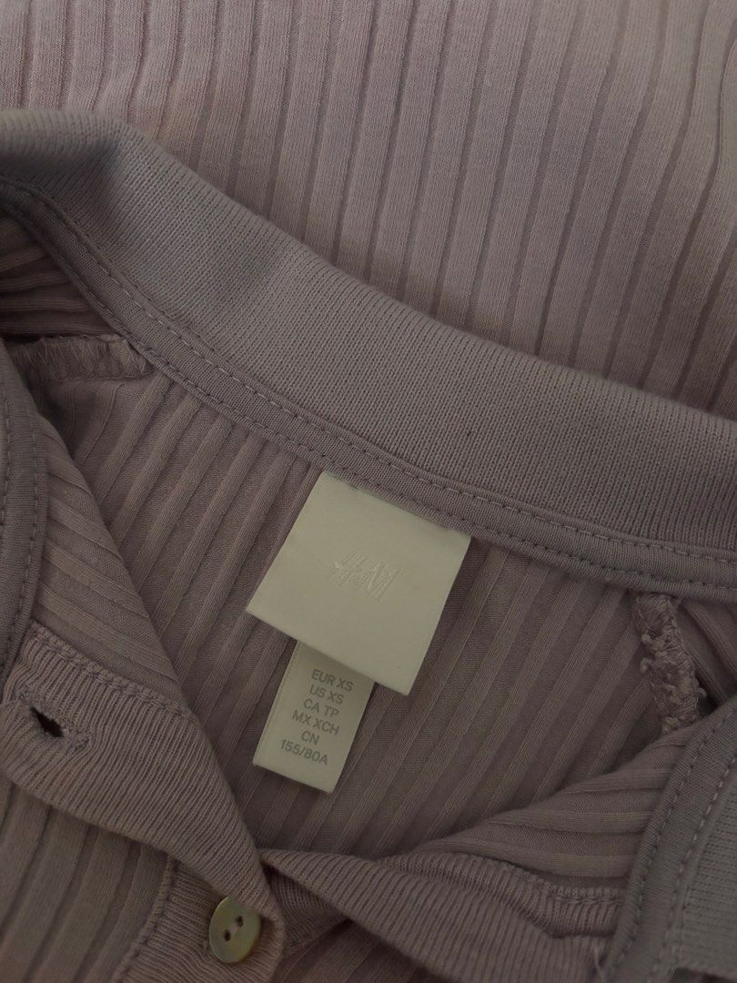 H&M Ribbed Collared Button-Up Short Sleeve Top XS (Category: Blouses) located in Manila. Submitted by mitzdcstr6 (Listing ID 1460004226, Image 2). Description: - Cute lilac ribbed top from H&M - Size XS - Short sleeves - Collared neckline - Button-up front - Versatile: pairs well with jeans or skirts - Super comfy and easy to wear.