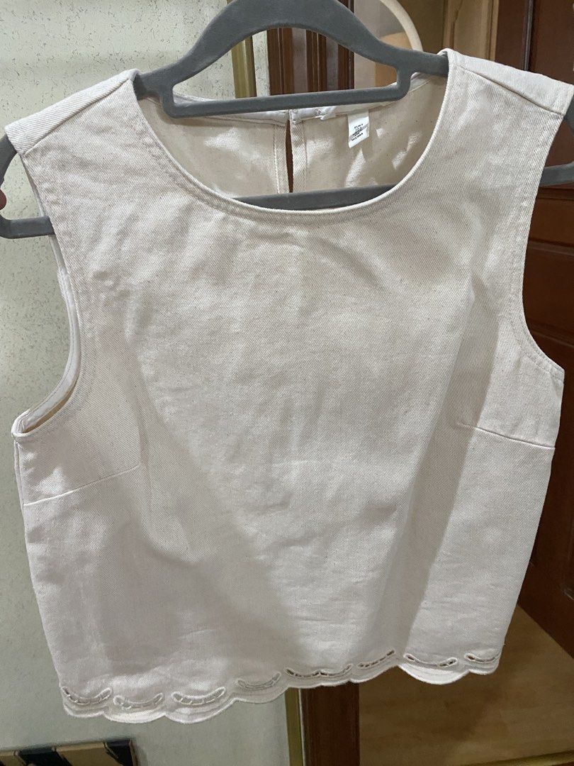 H&M Sleeveless Top with Scalloped Hem (Category: Sleeveless) located in Pasig City. Submitted by secondxclaimx (Listing ID 1459980423, Image 1). Description: - Cream sleeveless denim material top from H&M - Size S (fits Small to Medium) - Features a cute scalloped hem - Adorable cut-out details - Convenient button closure at the back - Versatile for casual outings or dressing up - Falls right by the waist.