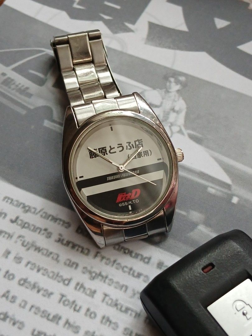 INITIAL D "FUJIWARA Tofu Shop", Quartz (Category: Luxury Watches) located in Tabaco. Submitted by igoys-watches (Listing ID 1459972746, Image 2). Description: INITIAL D "FUJIWARA Tofu Shop", Quartz (UNISEX) ✅️Good Running Condition ✅️Clean Dial ✅️All Original ✅️Crystal is in great condition ✅️Luminous Hands ✅️Double-lock Steel Strap ✅️Highly Collectible ✅️Produced by BANPRESTO in 2002 ✅️Rare and Discontinued ✅️Hard to find 😎 ✅️Perfect for INITIA