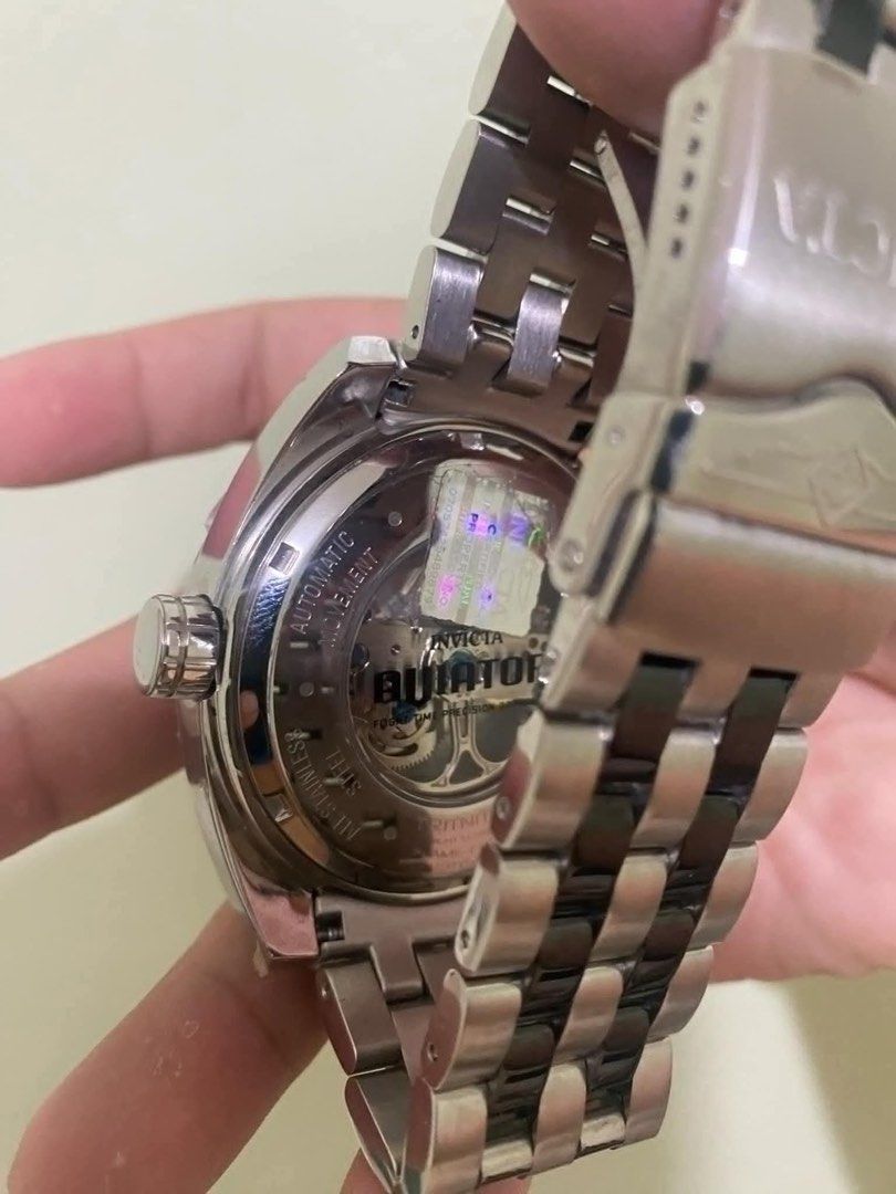 Invicta Aviator Automatic Mens Watch (Category: Men's Watches) located in Cavite. Submitted by Xteespreluhvd (Listing ID 1459962516, Image 3). Description: Invivta Aviator Automatic Mens Watch This is an Invicta Aviator Automatic men's watch. The dial is silver tone with an open heart design showing the Automatic movement. It has a stainless steel case, a bezel with cable accents and a black silicone band. It's water resistant to a depth of 100 m