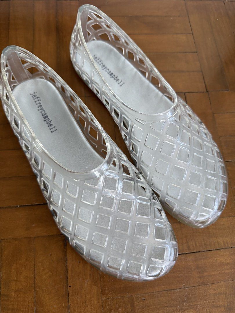 Jeffrey Campbell Clear Jelly Flats (Category: Flats & Sandals) located in Makati City. Submitted by curatedandnearlynew (Listing ID 1460023774, Image 1). Description: - Brand: Jeffrey Campbell - Style: Clear jelly flats - Design: Unique lattice pattern - Features: Easy slip-on, flexible material - Comfort: Comfortable for all-day wear - Occasion: Great for casual outings or beach days - Fun addition to any outfit.