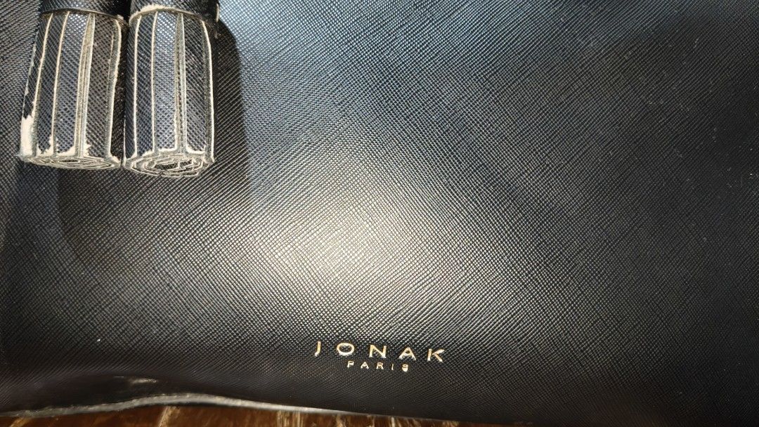Jonak Paris two way leather bag (Category: Luxury Bags & Wallets) located in Quezon City. Submitted by morningstar_52 (Listing ID 1460084401, Image 2). Description: - Brand: JONAK PARIS - Color: Black - Material: Textured Leather - Features: Top handle, detachable shoulder strap, cute tassel charm - Hardware: Gold details - Closure: Zipper top - Versatile: Ideal for everyday use or nights out.