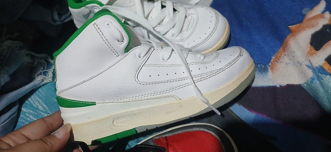 Jordan 2 Toddler Sneakers White Green (Category: Babies & Kids Fashion) located in Cavite. Submitted by crispeleno90843 (Listing ID 1459943396, Image 3). Description: - Toddler Jordan 2s - High-top style - White with green accents - Ideal for toddlers learning to walk/run - Minor scuffs on toe and sole - Clean laces.