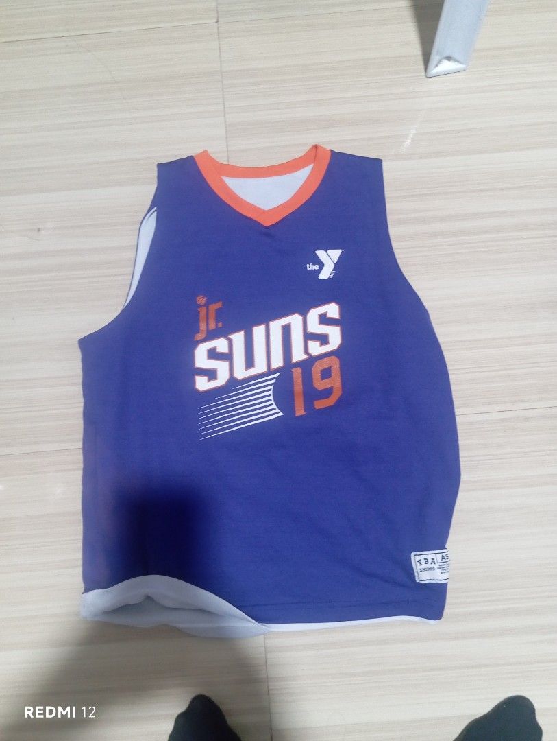 Jr. Suns 19 Basketball Jersey (Category: Activewear) located in Sariaya. Submitted by angelochintes732 (Listing ID 1460025246, Image 2). Description: - Reversible basketball jersey - Side 1: White with orange and purple trim - Side 2: Purple with orange and white trim - Features 'Jr. Suns 19' graphic - Ideal for basketball practice or casual wear.